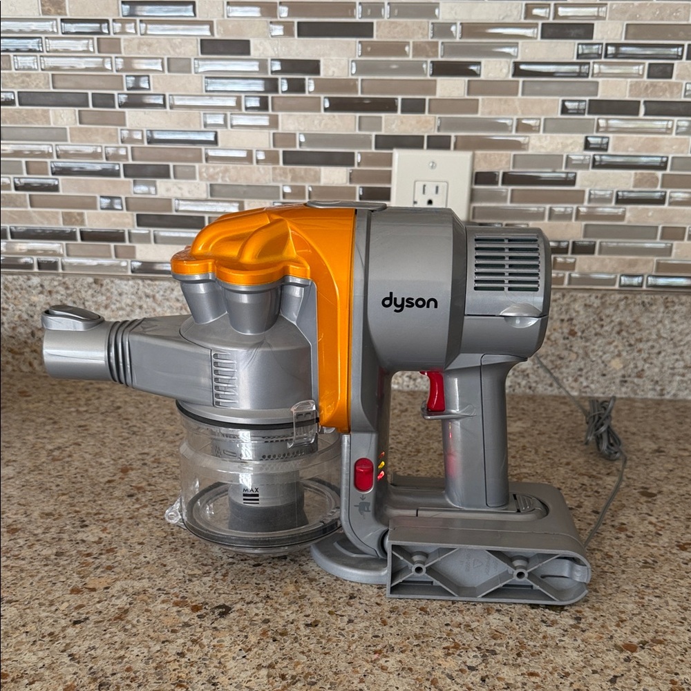Dyson Corded Handheld Vacuum in Silver and Orange Accents